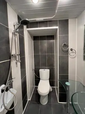 a bathroom with a toilet and a shower at Vi Del Mar Apartments Varna in Varna City