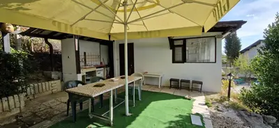 a patio with a table and an umbrella at Bungalow GHP-B in Varna City