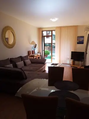 a living room with a couch and a table at Liliya in Sveti Vlas