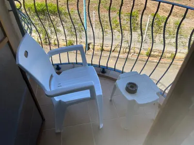 a blue chair sitting in front of a window at Camping Gradina Garden Beach b33 in Chernomorets
