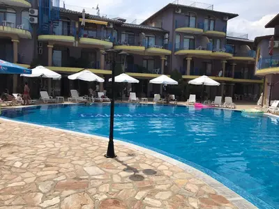 a swimming pool in front of a hotel at Camping Gradina Garden Beach b33 in Chernomorets