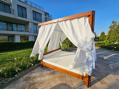 a bed with a mosquito net on a patio at Diamond Beach Sarafovo by KP - Luxury Collection, Apt 6 in Burgas City