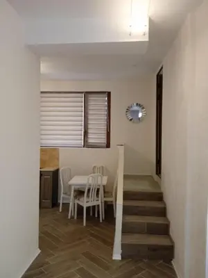 a dining room and kitchen with a table and chairs at Апартаменти Стефанов in Varna City