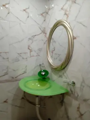 a bathroom with a green sink and a mirror at Апартаменти Стефанов in Varna City
