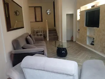 a living room with couches and a flat screen tv at Апартаменти Стефанов in Varna City