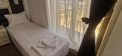 a bedroom with a bed and a window with towels at Penthouse Happy Moments in Sunny Beach