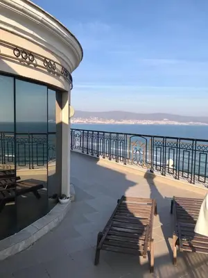 a view of the ocean from a building with benches at Penthouse Happy Moments in Sunny Beach