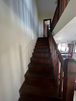 a stairway in a home with wooden stairs at Велика Гардън - Акация 6 in Lozenets