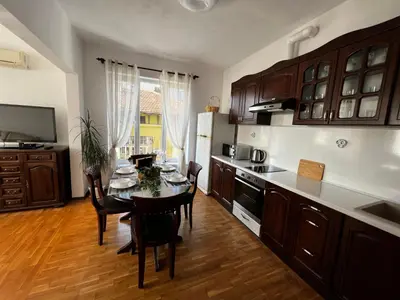 a kitchen with a table and chairs and a kitchen with at Апартамент Опера. Стил и комфорт. Идеален център. in Varna City