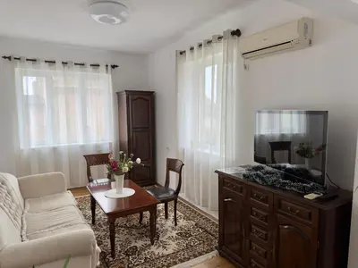 a living room with a couch and a tv at Апартамент Опера. Стил и комфорт. Идеален център. in Varna City