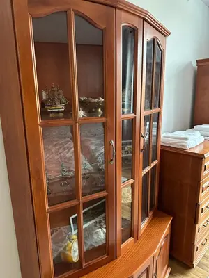 a wooden cabinet with glass doors at Апартамент Опера. Стил и комфорт. Идеален център. in Varna City