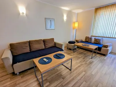 a living room with a couch and a table at Urlaub - Obzor Beach Resort A109 in Obzor