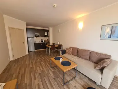 a living room with a couch and a table at Urlaub - Obzor Beach Resort A109 in Obzor