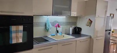 a kitchen with a sink and a refrigerator at Cozy apartment in the hart of the city in Varna City