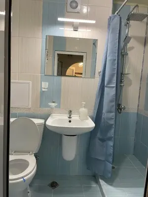a bathroom with a toilet and a sink and a mirror at Sity Home in Burgas City