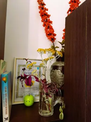 a vase with flowers in it sitting on a table at Оазис 1 във Варна in Varna City