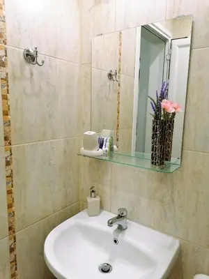 a bathroom with a white sink and a mirror at Оазис 1 във Варна in Varna City