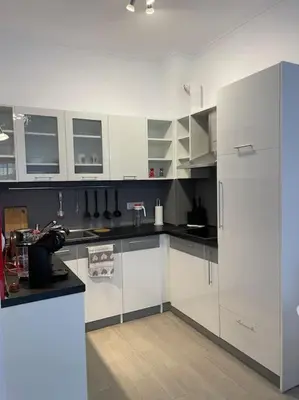 a kitchen with white cabinets and a refrigerator at Sonne, Meer und mehr in Nesebar
