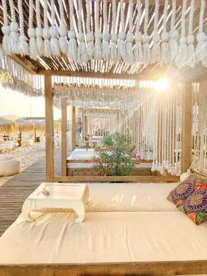 a bed in a pavilion with chandeliers at Dolce Vita Blue Boho, Premium Apartment with seaview in Sveti Vlas