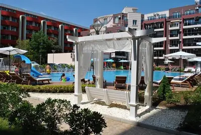 a white gazebo in front of a swimming pool at Deluxe Admiral Plaza in Sunny Beach