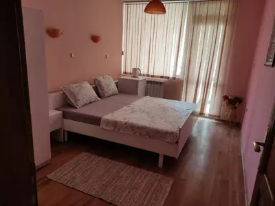 a small bedroom with a bed and a window at Стая за гости на град Бургас. in Burgas City