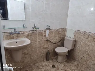 a bathroom with a toilet and a sink at Стая за гости на град Бургас. in Burgas City