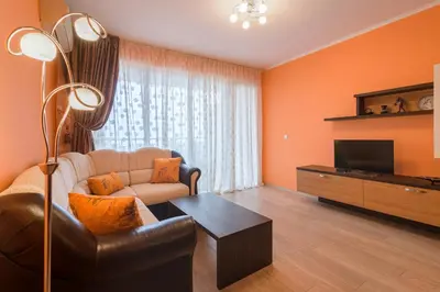 a living room with a couch and a television at Infinity View Shkorpilovci in Shkorpilovtsi