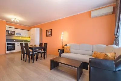 a living room with a couch and a table at Infinity View Shkorpilovci in Shkorpilovtsi