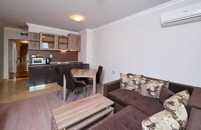 a living room with a couch and a table at Boutique Rose Gardens Pomorie in Pomorie