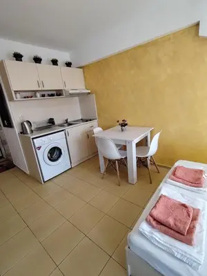 a kitchen with a table and a table and a table and a stove at Жасмин клуб in Sunny Beach