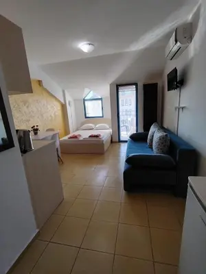 a large living room with a couch and a bed at Жасмин клуб in Sunny Beach