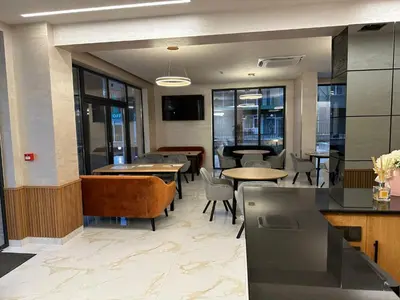 a restaurant with tables and chairs and tables and windows at Emilia Romana Park in Sunny Beach