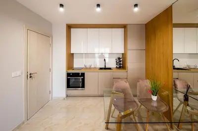 a kitchen with a glass table and chairs at Emilia Romana Park in Sunny Beach