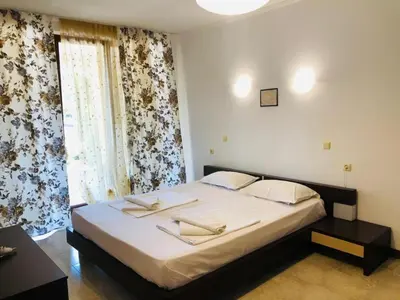 a bedroom with a large bed and a window at Grande Mia Casa in Sveti Vlas