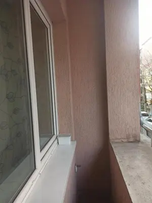 a window with a white ledge next to a building at Апартамент Александр 1 in Burgas City