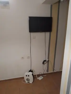 a room with a flat screen tv on a wall at Апартамент стоенчо хаджииванов,10 in Varna City
