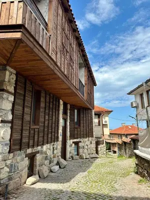 a wooden building with a balcony on the side of it at Sozopol Old Town - Apartment 3 in Sozopol