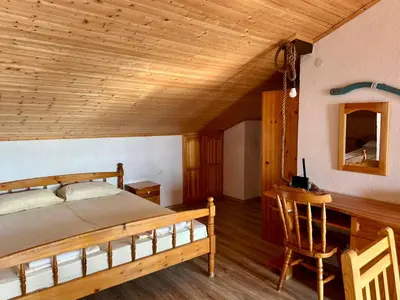 a bedroom with a bed and a wooden ceiling at Sozopol Old Town - Studio 5 Attic in Sozopol