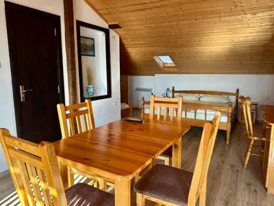 a dining room with a wooden table and chairs at Sozopol Old Town - Studio 5 Attic in Sozopol