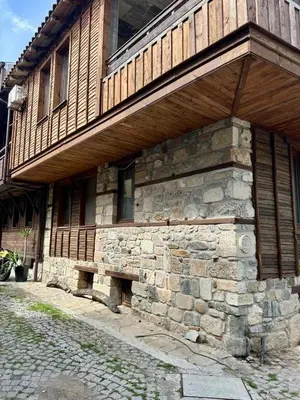 a stone building with a bench on the side of it at Sozopol Old Town - Studio 5 Attic in Sozopol