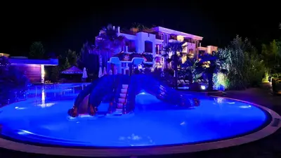 a swimming pool with a slide in front of a house at Attractive Family Apartment in Sunny Beach Cascadas Family Resort in Sunny Beach