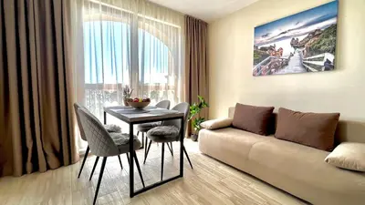 a living room with a couch and a table at Attractive Family Apartment in Sunny Beach Cascadas Family Resort in Sunny Beach