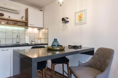 a kitchen with a table and two chairs at Студио в близост до Община Варна in Varna City