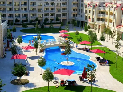 an overhead view of a swimming pool with red umbrellas at Апартаменти Варна Саут на плажа 2 - Varna South Apartments on the beach 2 in Varna City