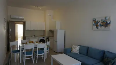a living room with a couch and a table and a kitchen at Апартаменти Варна Саут на плажа 2 - Varna South Apartments on the beach 2 in Varna City