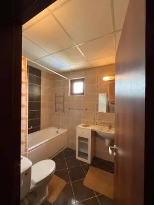 a bathroom with a toilet and a tub and a sink at Sunrise Splendid in Obzor