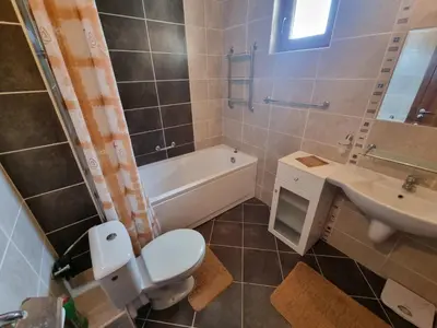 a bathroom with a toilet and a sink and a tub at Sunrise Splendid in Obzor