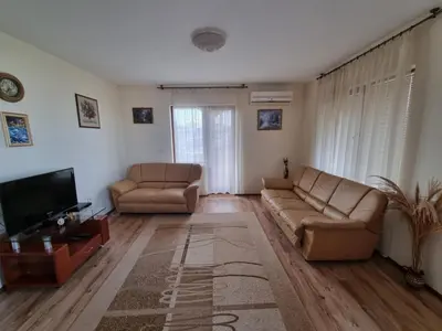 a living room with two couches and a television at Sunrise Splendid in Obzor