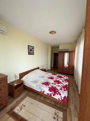 a bedroom with a bed with a red and white blanket at Sunrise Splendid in Obzor