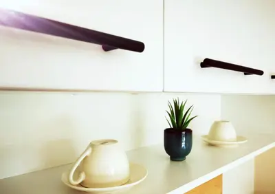 a kitchen counter with two dishes and a plant on it at Студио Sun day в Royal palm, Свети Влас in Sveti Vlas